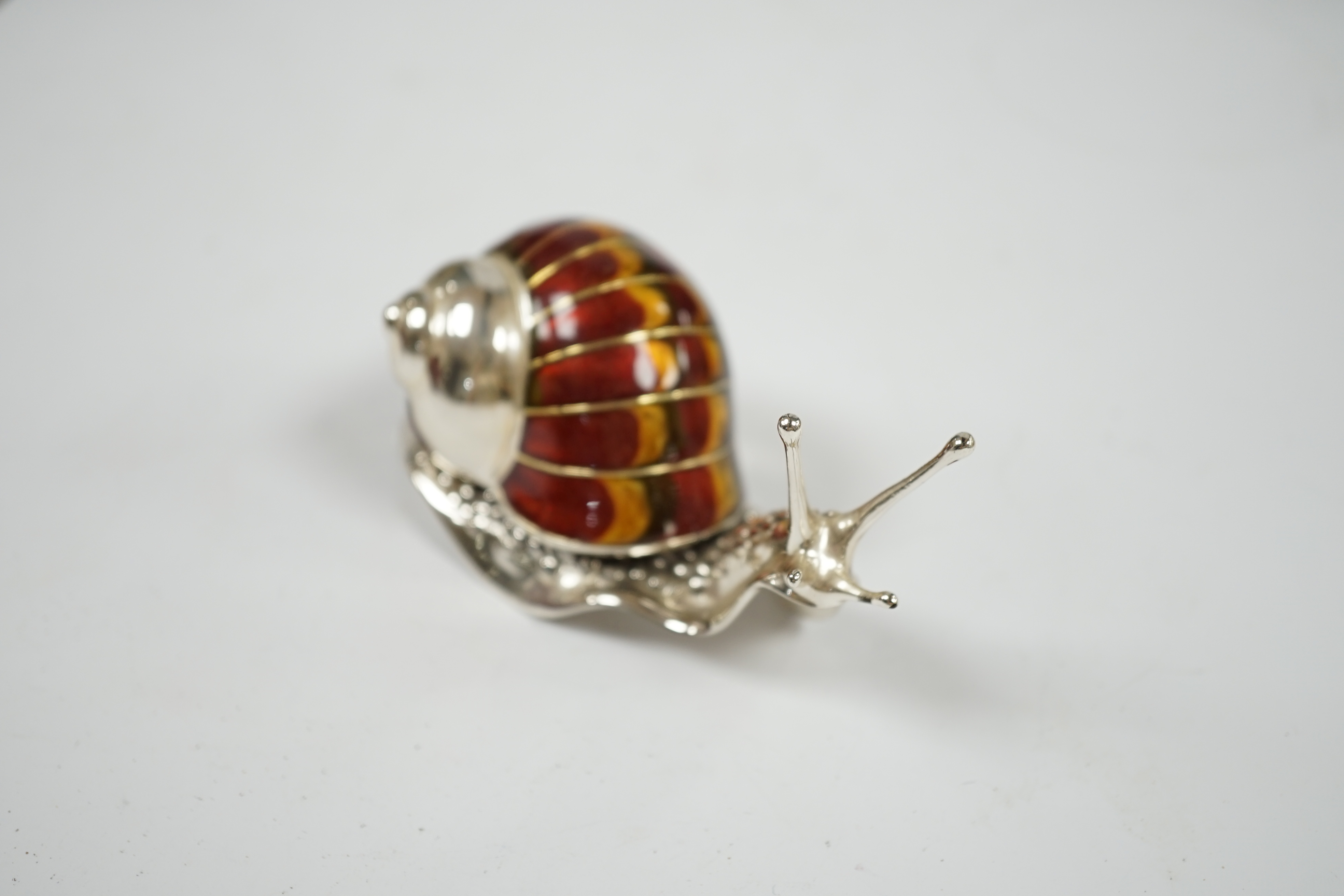 A Saturno silver and enamel model of a snail, by Francis Howard, length 10cm, gross weight 5oz. Condition - good